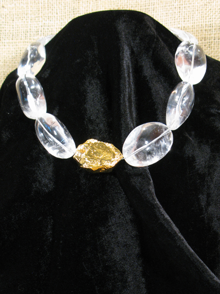 
CLEAR QUARTZ WITH GOLD VERMEIL NUGGET AND CLASP ON BLACK VELVET