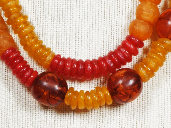 
2 STRANDS GOLDEN, RED, and ORANGE OLD AFRICAN GLASS BEADS WITH GOLD PLATED CLASP