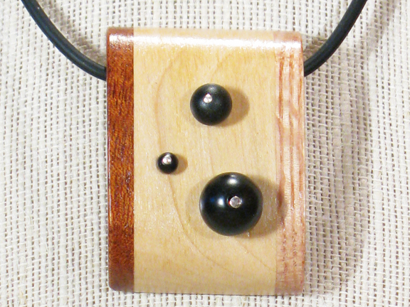 
3 WOODS-MAPLE, MAHOGANY & OAK LAMINATED AND 3 BLACK ONYX BALLS WITH RUBBER COLLAR